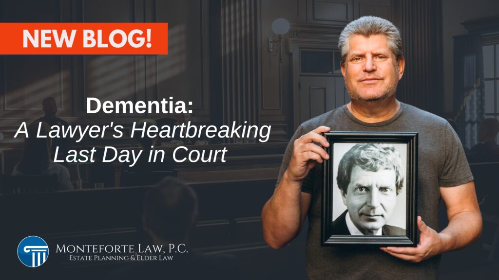 A man holds up a black and white framed picture of an older man in front of a court room